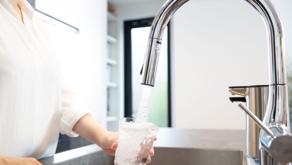 Safe tap water pouring water into a glass.