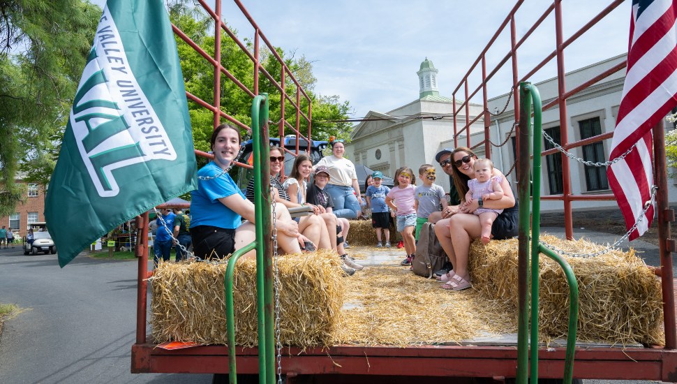 Families sit in truckbed for hayride.