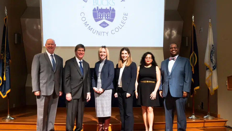 Dr. Patrick M. Jones (left), President and CEO of Bucks County Community College; BCCC Board of Trustees Chair Thomas J. Jennings; Dr. Lynette Kuhn, Pennsylvania Department of Education Deputy Secretary and Commissioner for Postsecondary and Higher Education; School of Social and Behavioral Sciences Dean Dr. Samantha Gross; student Siam Rodriguez; and Vice President of Student Affairs Dr. Samuel Coleman.