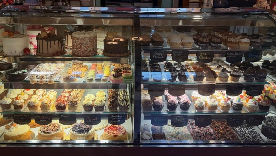 Cupcakes and cakes in a display case at The Caketeria.