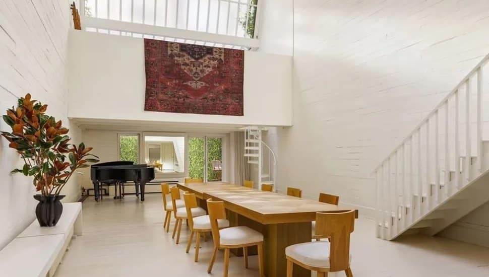 Dining room with skylight, large table, and piano.