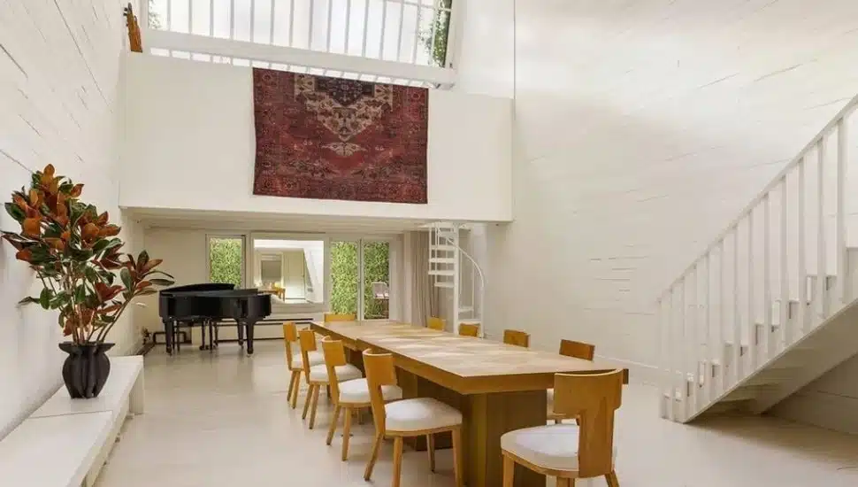 Dining room with skylight, large table, and piano.