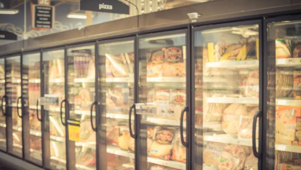 Frozen pizza aisle in grocery store.