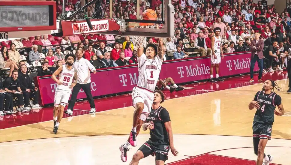 Jalil Bethea slam dunking a basketball during a game.