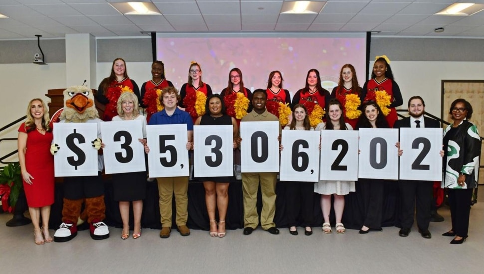 College students and faculty celebrate fundraising milestone.