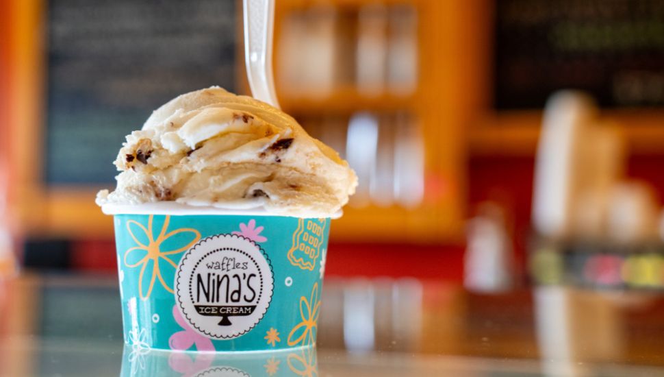 Ice cream in a cup on a counter at Nina’s Waffles & Ice Cream.
