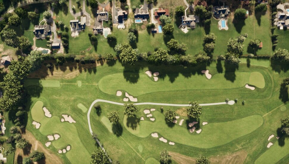 Aerial view of Hole 4 at Aronimink Golf Course next to some houses.