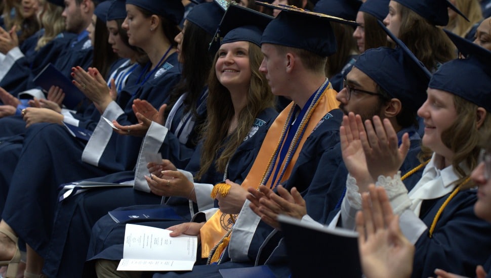 Kristina Novak (center), who graduated from Bucks County Community College with an associate degree in health sciences, was named the 2026 President’s Cup recipient for her outstanding contribution to the college community through student activities, service, and leadership. She was among several hundred graduates who participated in the College’s 60th Annual Commencement May 21.