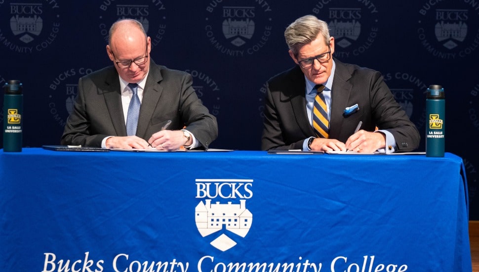 Bucks County Community College President & CEO Patrick M. Jones (left) and La Salle University President Daniel J. Allen (right) signed two new transfer agreements May 11 at the College’s Newtown Campus.