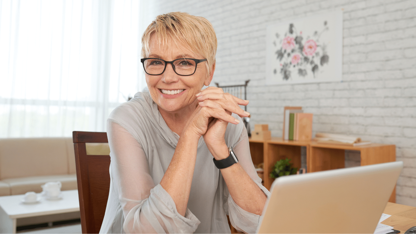 A senior works at her laptop.