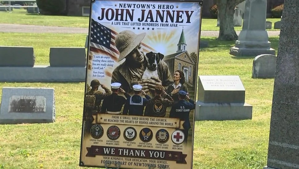 A memorial poster honoring John Janney, displayed at Newtown Cemetery during Monday's ceremony.