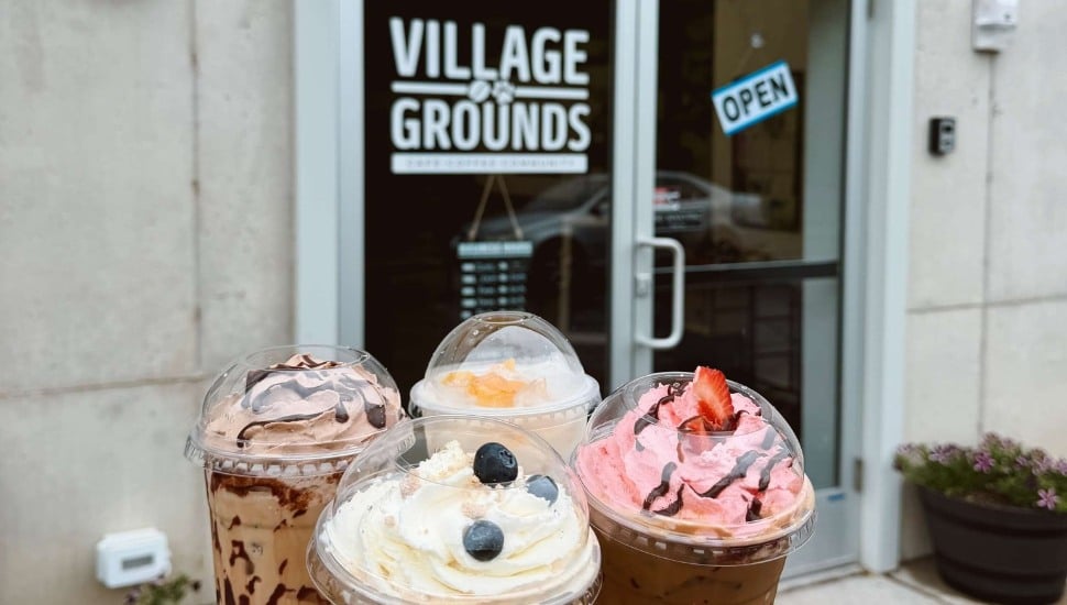Village Grounds Cafe's specialty drinks outside the café exterior.
