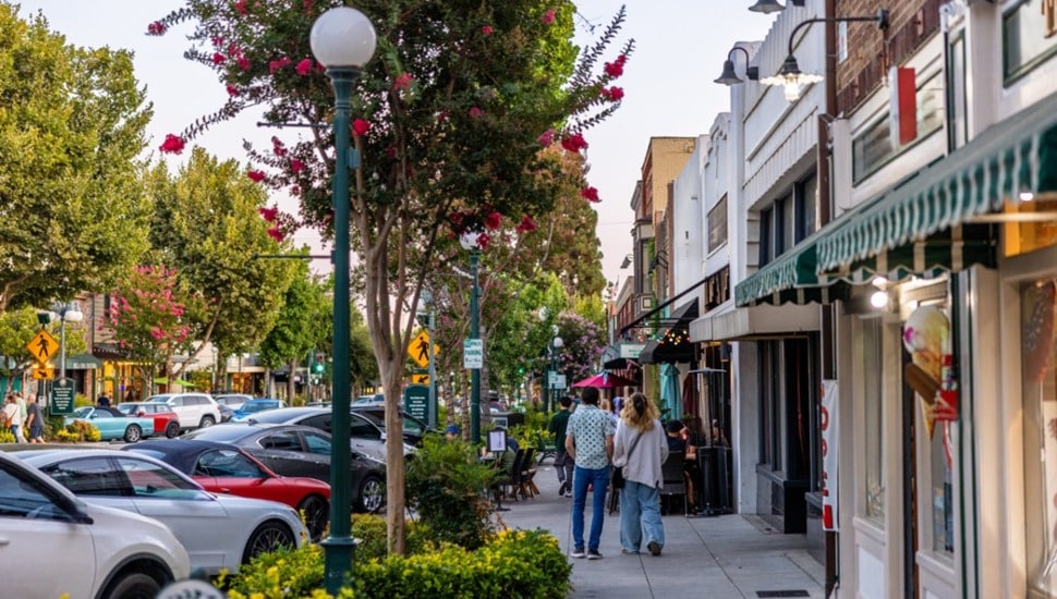 Couple walks down main street.