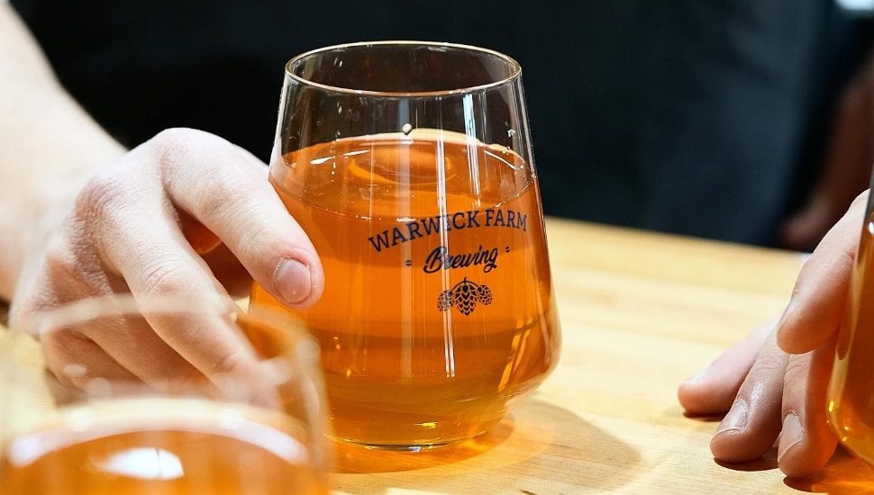 a patron nurses a cold beer at Warwick Farm Brewing.
