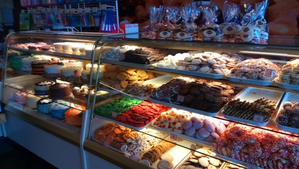 The display case at Fritz's Bakery in Bensalem tells the story before a single bite is taken — cookies, brownies, macaroons, cakes, and pastries, all scratch-made and stacked fresh daily, just as they have been since 1974.