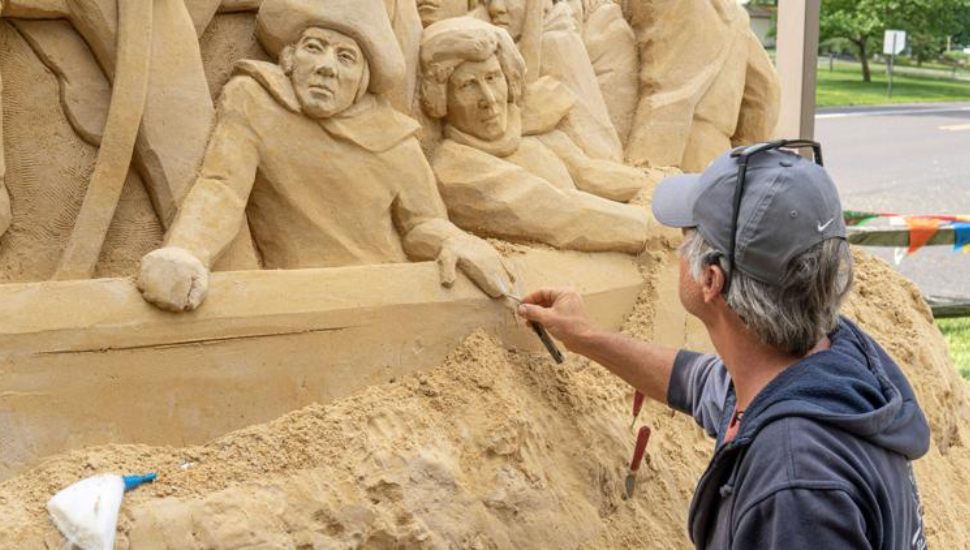 A sand sculptor at work on the Sights in Sand: An American Road Trip exhibit, now in its fourth weekend at Peddler's Village in Lahaska.