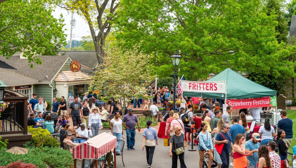Crowds fill the brick pathways of Peddler's Village during the annual Strawberry Festival in Lahaska, one of dozens of seasonal events that draw millions of visitors to the Bucks County landmark each year.