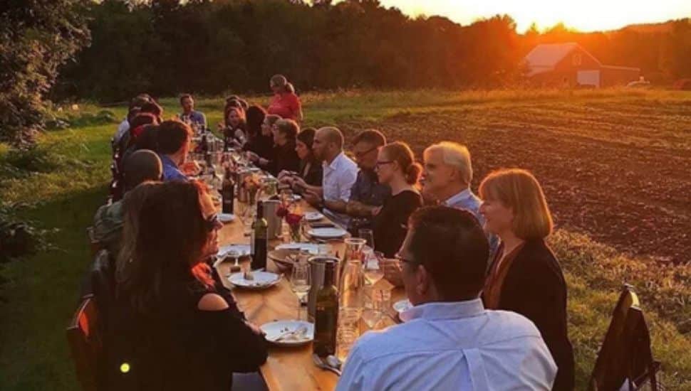 A communal dinner at Roots to River Farm captures the spirit behind founders Malaika Spencer and Ian Knauer's vision: fresh food, shared tables, and a connection to the land.